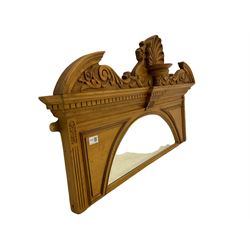 Late 19th century polished pine architectural mirror, arched bevelled plate