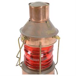 Copper ships lantern with red glass, marked NUC with brass handles and fittings, H46cm
