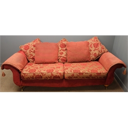  Three seat traditional shaped sofa, upholstered in red and gold floral fabric with striped scatter cushions, turned walnut finish feet with castors, W235cm, H72cm, D100cm  