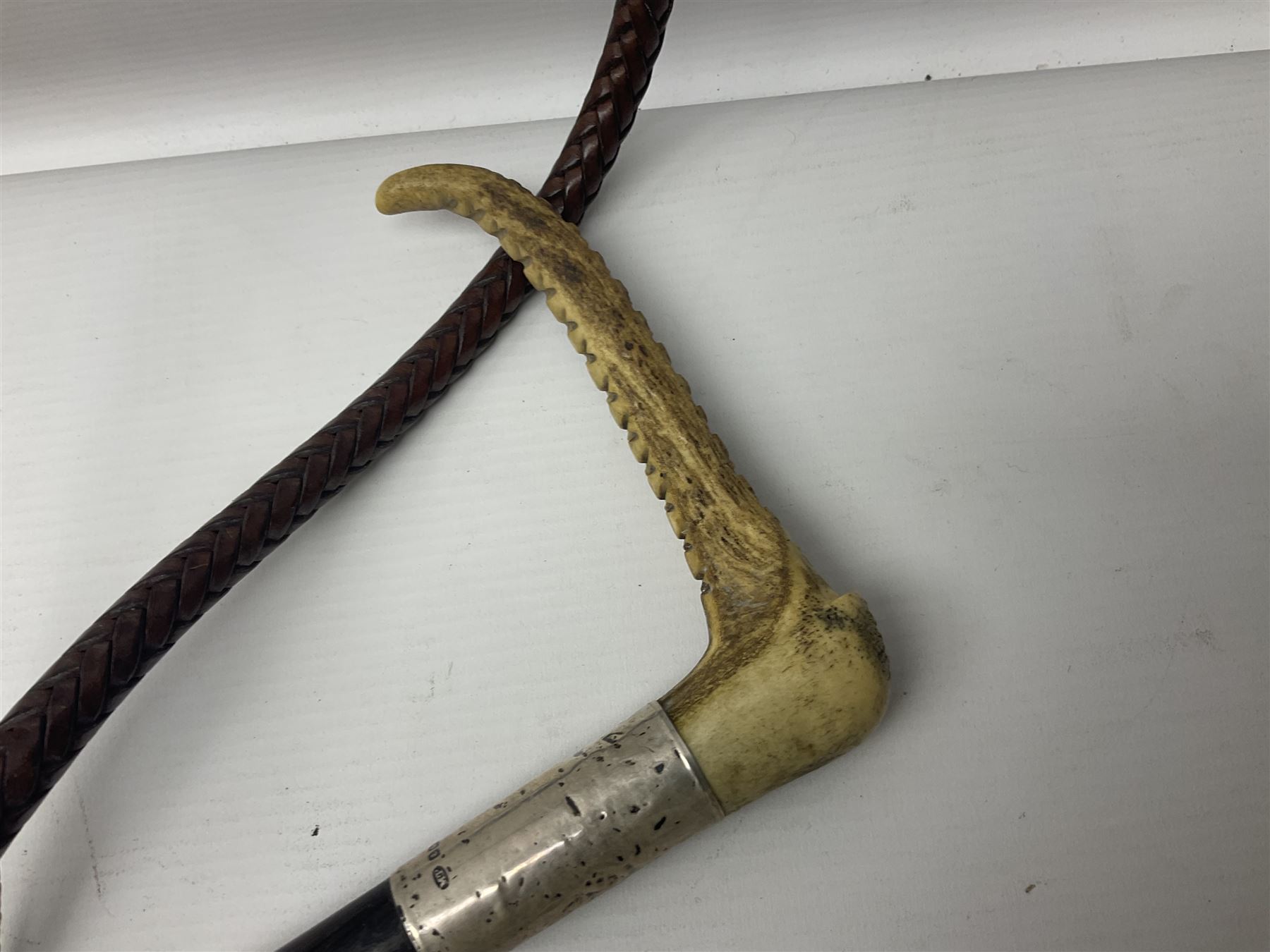 Collection of hunting crops and riding whips, including horn handle examples with silver cuffs