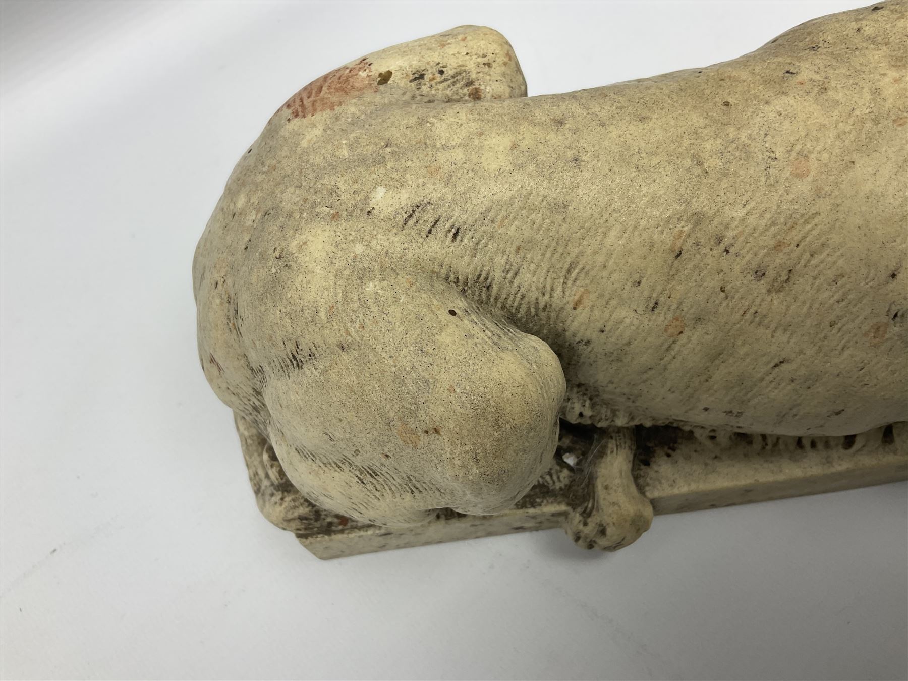 Two early 20th century reconstituted stone Grand Tour or Chatsworth House type lions after Antonio Canova, each modelled in recumbent pose upon a rectangular plinth, signed to plinth Dilettanti, each approximately L31cm