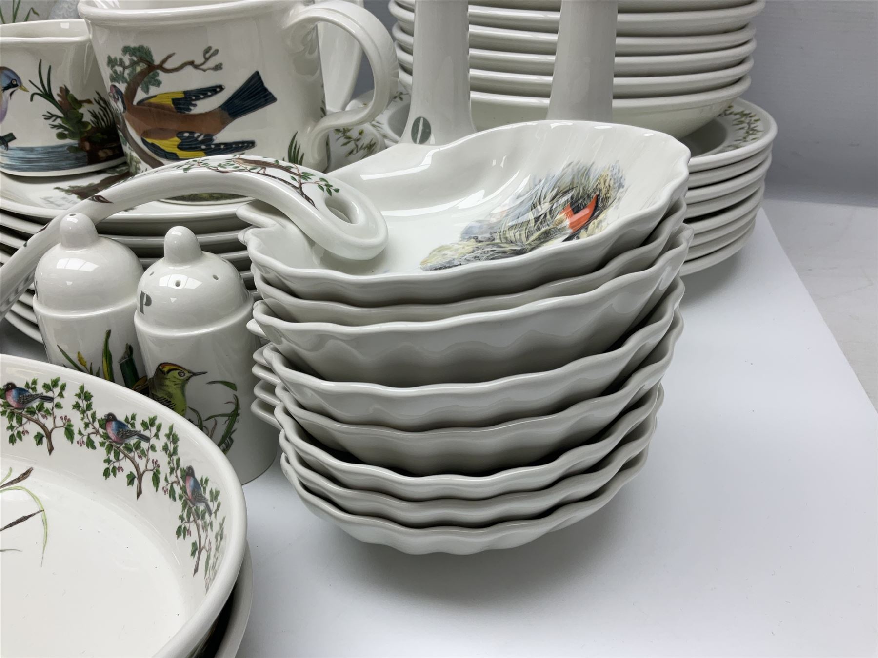 Portmeirion Birds of Britain pattern, dinner service for eight, to include covered soup tureen with ladle, dinner plates, soup bowls, side plates, oval plates, a serving platter, two oval serving dishes, salt and pepper, etc and eight shell dishes in the British fish pattern (56) 