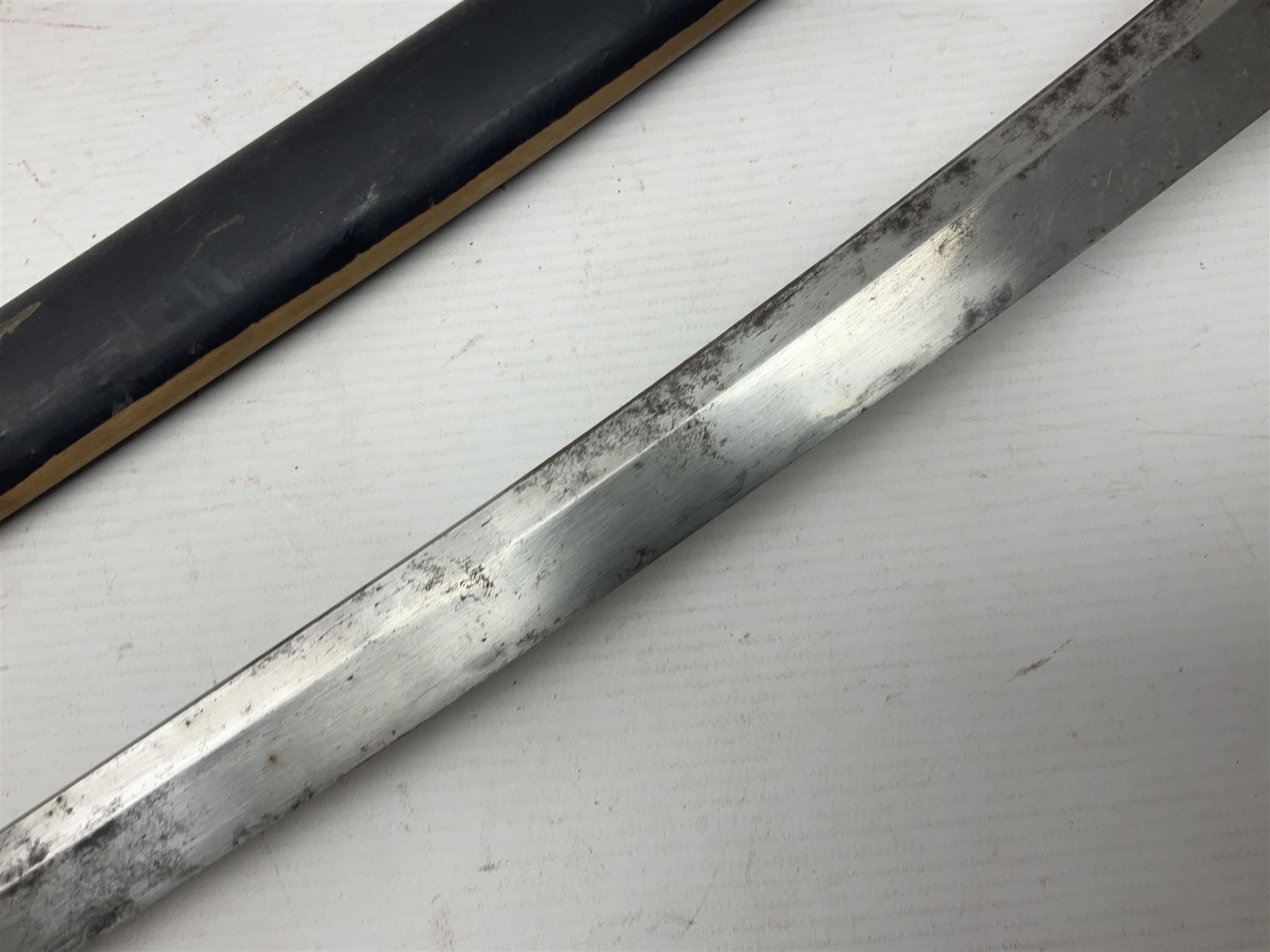 Good quality Japanese sword blade with later WWII fittings and scabbard  - 67.5cm slightly curving blade with unmarked tang, plain iron tsuba and lacquered grip with copper mounts; in lacquered wooden scabbard with tape bound tip L94cm overall