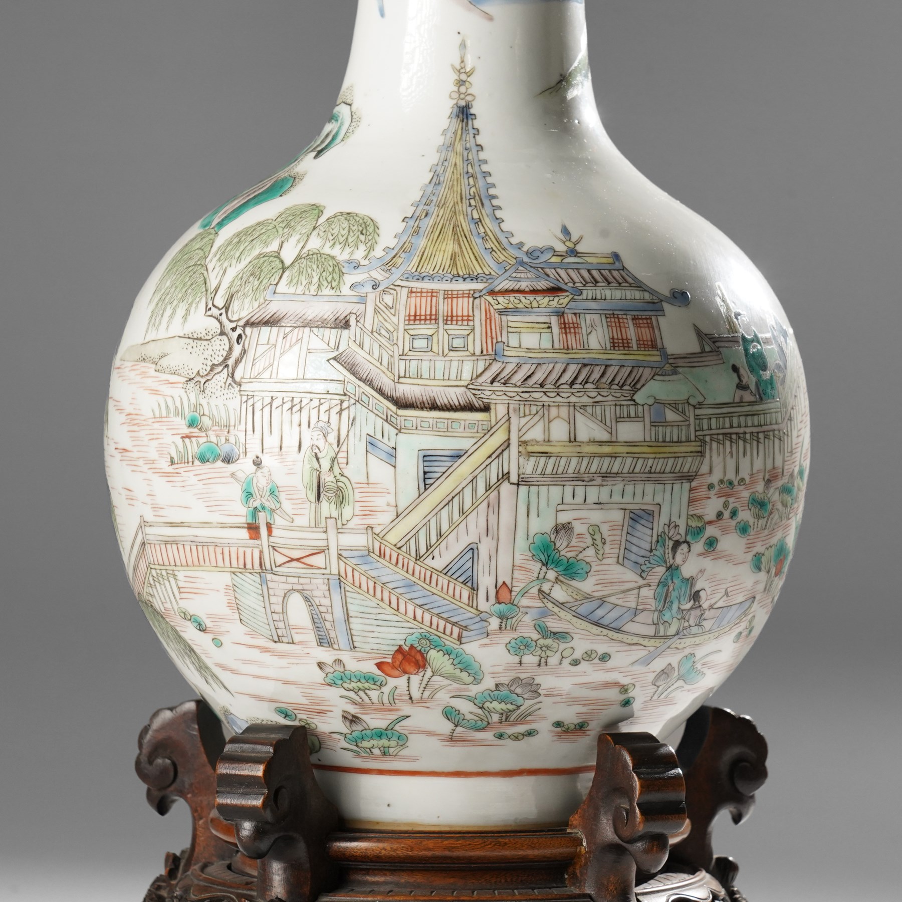 Chinese Kangxi period famille verte vase, the body finely painted with a continuous narrative scene of figures inside and out of a pavilion complex, beside a river, rocks and trees, character mark to base, raised upon a hardwood stand, overall H47cm