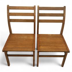 Treske of Thirsk - solid oak refectory dining suite, rectangular top with chamfered edge over trestle base united by a central stretcher, together with six matching slat back dining chairs, including two carvers, with panelled seats and square legs united by stretchers (H 87cm, W 62cm, D 57cm)