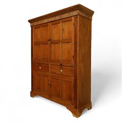 Victorian stripped pine kitchen cupboard, of rectangular form with fluted cornice and top section with two panelled cupboard doors revealing painted shelved interior, middle with two drawers with turned knob handles and brass cup handles, base section with two panelled cupboards, raised on shaped bracket feet 