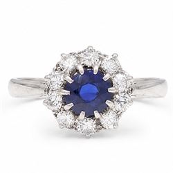 Platinum sapphire and diamond cluster ring, single round cut sapphire of approx 0.85 carat...