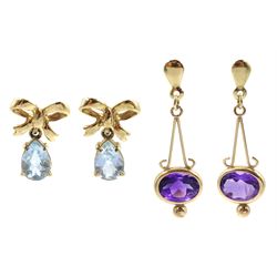 Pair of gold oval amethyst pendant stud earrings and a pair of gold blue topaz bow pendant stud earrings, both hallmarked 9ct