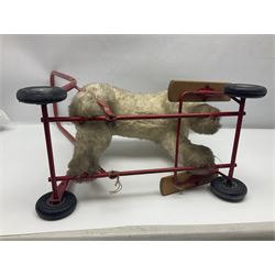 Tri ang - Pedigree Soft Toys - push along/ride-on dog as a wood wool filled plush Airedale terrier in red tubular frame with beech footrests and black rubber wheels; stitched Northern Ireland label in tact L60cm H61cm