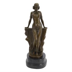 After Milo; Egyptian lady leaning on a wall with sphinx carving, upon a stepped oval base H25cm