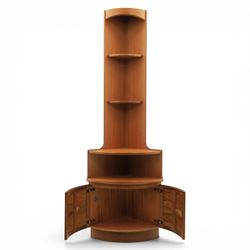 Nathan - teak corner cabinet, the upper section with moulded cornice and two fixed shaped open shelves, above a curved corner cupboard with twin signature square panelled doors, on a shaped plinth