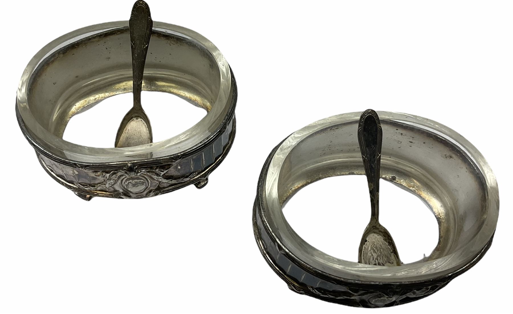 Two Georgian silver toddy ladles with baleen twist handles, (neither hallmarked), one with inset coin to bowl, together with a group of silver plate including cruet stand enclosing two glass bottles with stoppers, shaker and preserve pot with spoon, pair open salts with glass liners, etc. 