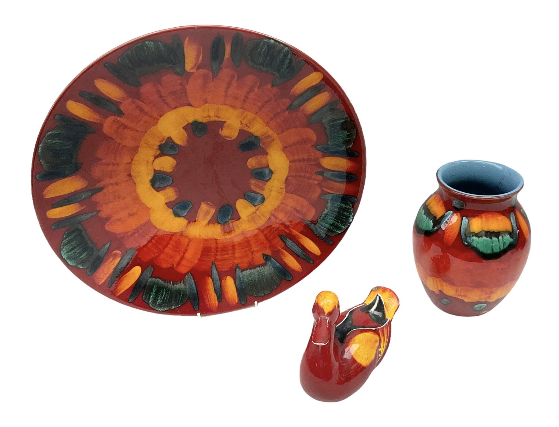 Collection of Poole Pottery, comprising charger and vase in Volcano pattern and a duck figure in a similar pattern 