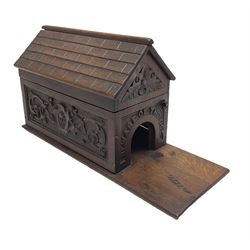 Late Victorian oak box in the form of a dog kennel with hinged roof, carved panels to the sides and arched opening to one end titled 'Beware of the Dog', the interior with lift-out rack of twenty-one holes and typed label 'This article is made from an old piece of oak taken from Lord Nelson's old ship the Foudroyant which was wrecked at Blackpool 1897 J.M.J.' L28.5cm
