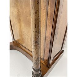 Early Victorian figured mahogany dressing cabinet, the raised shell and scroll carved back lifts to reveal rectangular easel mirror with mahogany band, flat rectangular top with tooled leather inset, slide at each side with matching leather inset, full width drawer above cupboard enclosing a series of five drawers, turned front supports, panelled front, sides and back