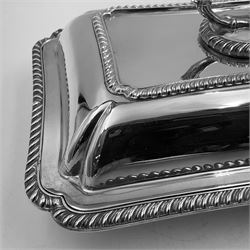 Early 20th century silver entree dish and cover, of rectangular form with shaped corners and oblique gadrooned borders to base and cover, the cover with loop 'bamboo' handle, hallmarked Thomas Bradbury & Sons Ltd, Sheffield 1930, including handle H10.5cm L24.5cm