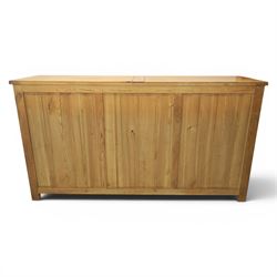 Contemporary oak sideboard, with rectangular top above three drawers and three cupboard doors, blackened metal handles, raised on stile supports