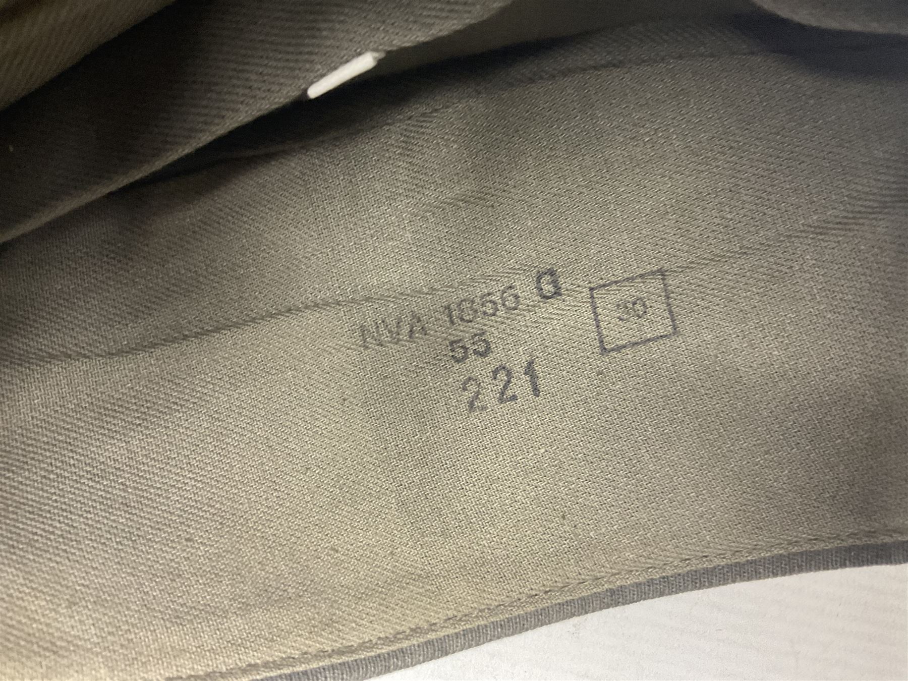 Four side caps - WW2 Russian, post-WW2 Russian and two East German; all with badges, one with multiple metal badges (4)