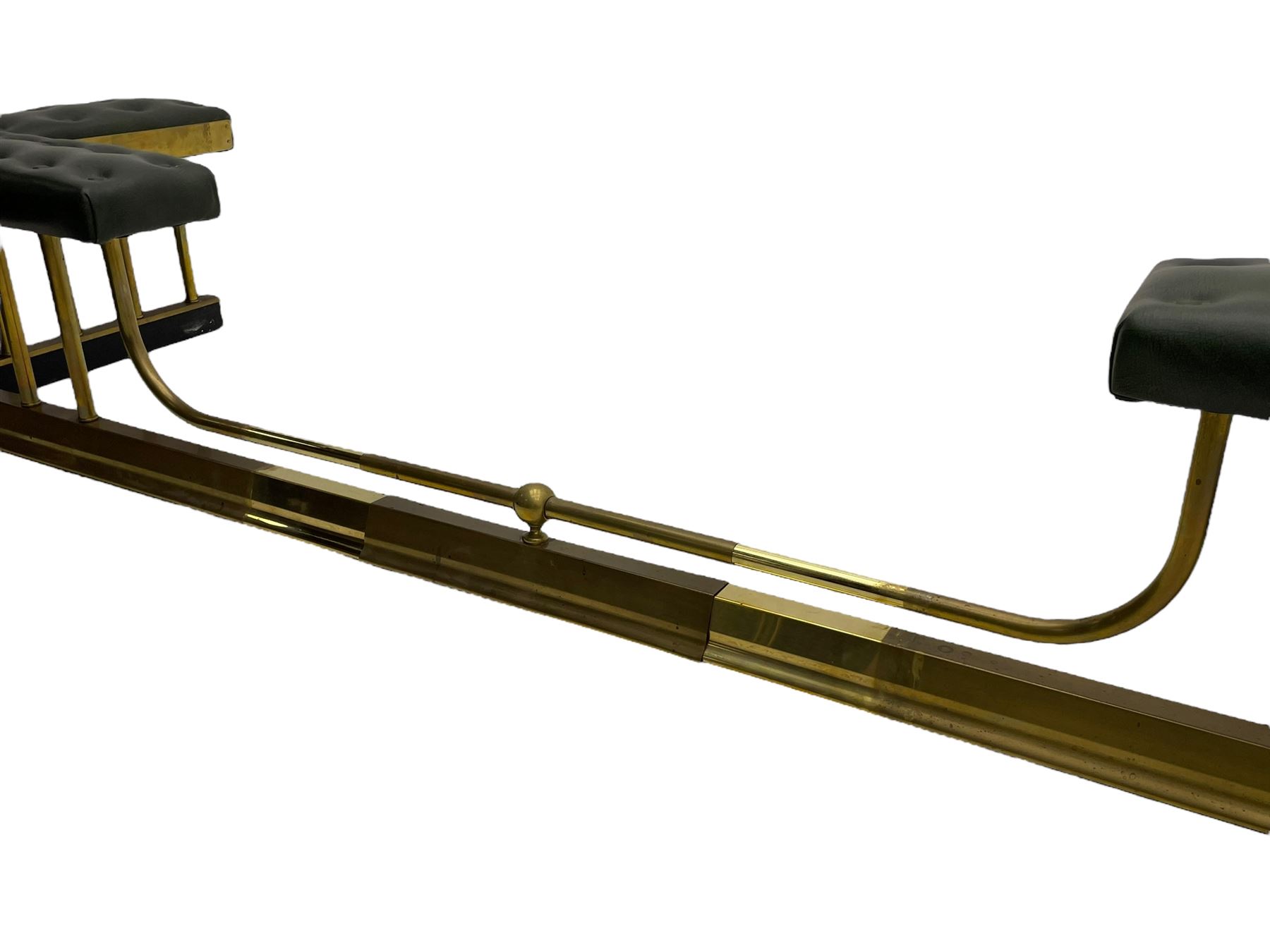 Victorian design brass telescopic extending club fire fender, the corner seats upholstered in buttoned green fabric over plain balustrade, on moulded base with floral cast corner brackets 