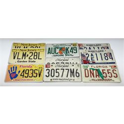 Nine American licence plates including three Florida, two New Jersey and four Maryland plates. 