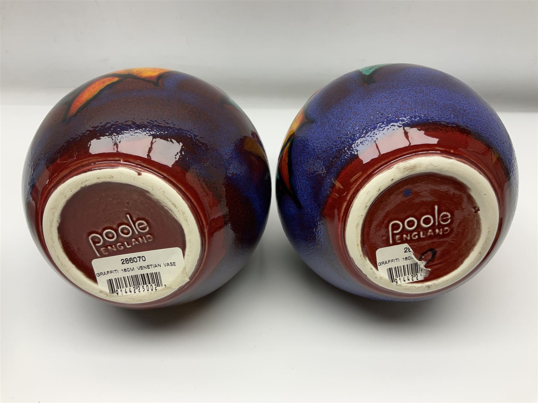 Four pieces of Poole Pottery in Graffiti pattern, comprising pair of vases of baluster form, dish and small plate, with impressed or printed marks beneath, vase H17cm