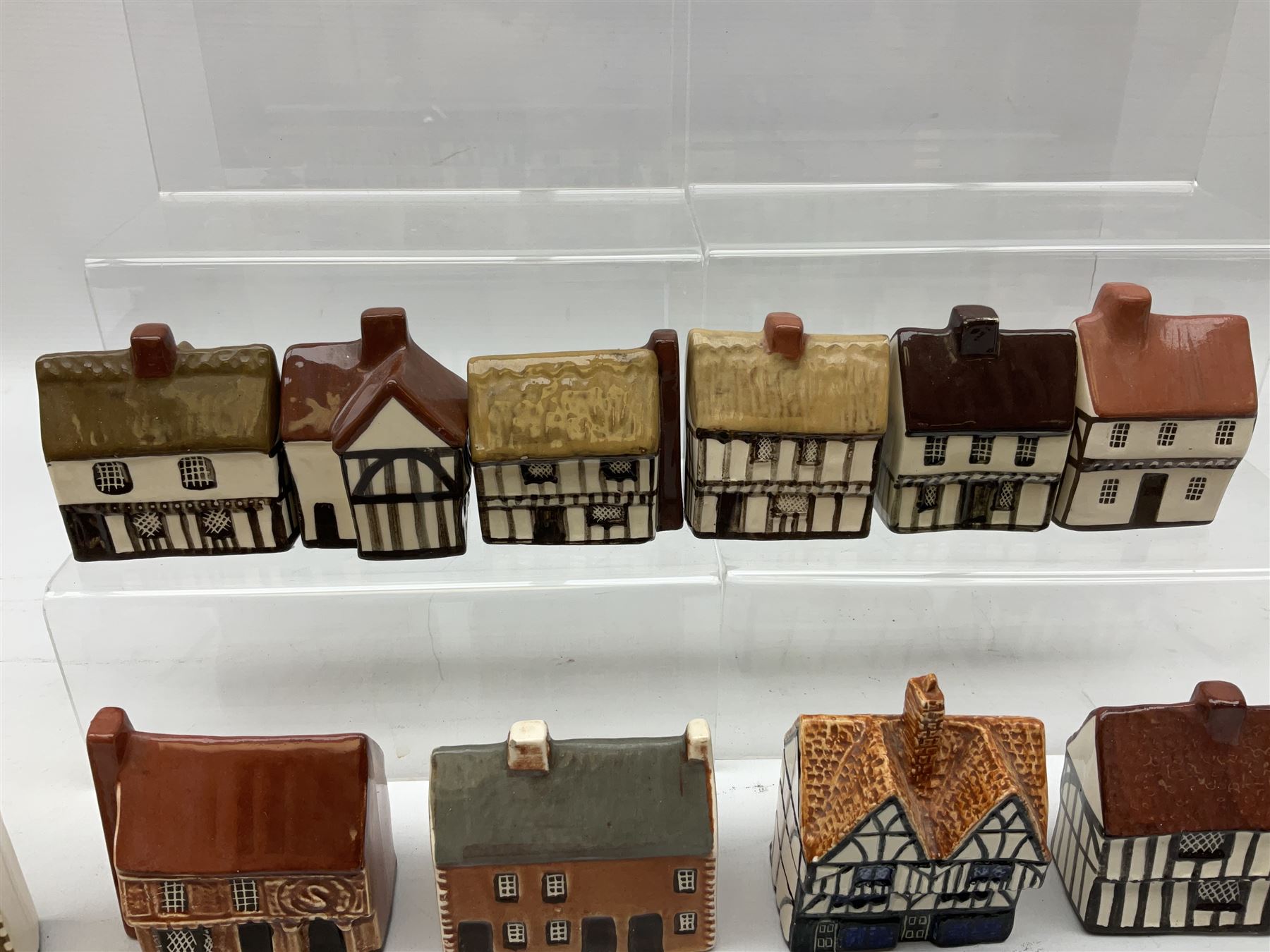 Twenty studio pottery figures of houses and cottages, comprising seventeen Mudlen End Studio Felsham Suffolk examples and two John Putman's Heritage Houses examples