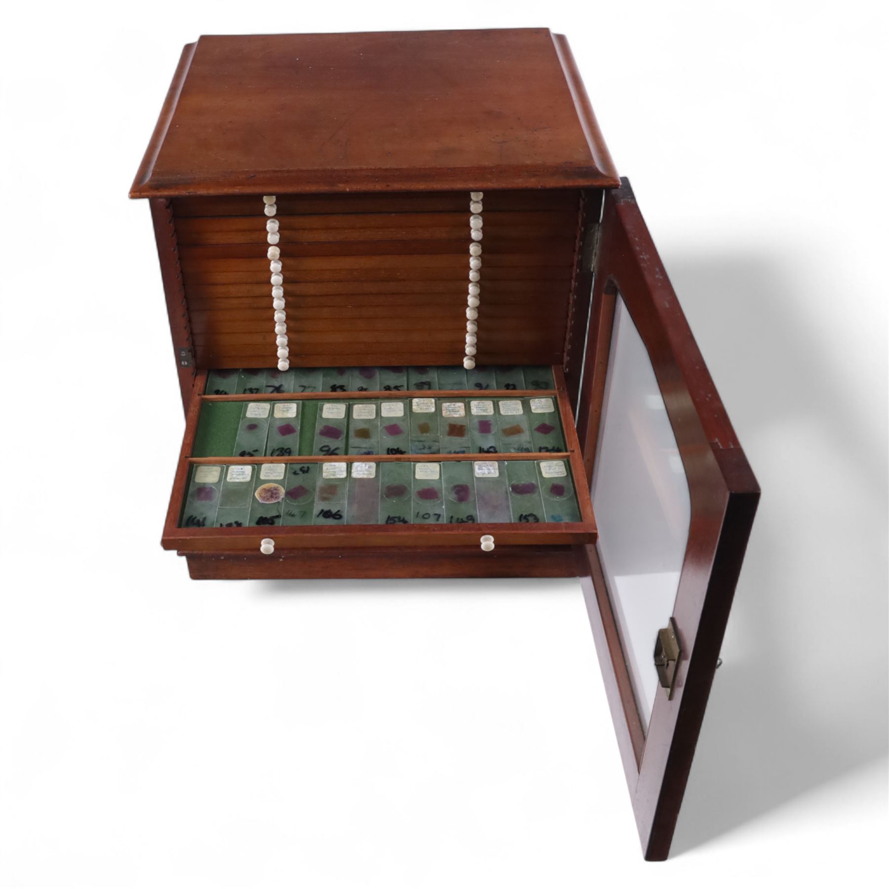 Victorian collector's specimen cabinet, containing a number of prepared microscope slides including miniature photographs, animal and human pathological, physiological and histological specimens and botanical specimens, mostly annotated in ink, the cabinet with glazed door, the drawers with bone handles and lined with green felt, owned by Dr Arthur Bristow, together with a picture of the doctor, cabinet H43cm