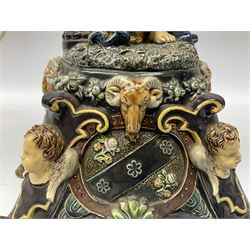 Composite table lamp modelled as a Roman Emperor donning blue robes, upon quatrefoil base modelled with rams heads and winged cherubs, H56cm excl fitting