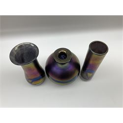 Group of Phoenician Malta art glass vases, all decorated with iridescent amethyst swirl pattern, comprising a spherical example, cylindrical example and baluster shaped example with flared rim, all signed beneath, tallest H20.5cm