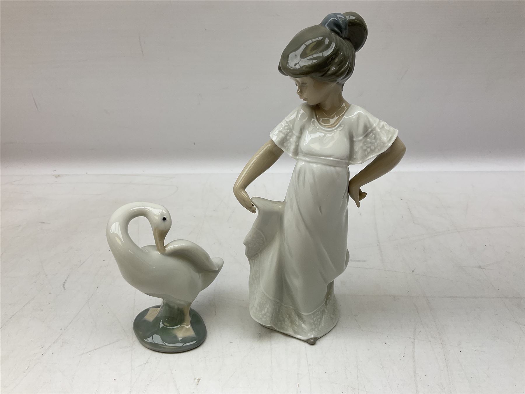 Quantity of figures to include Lladro example modelled as swan together with three Nao figures to include two April Showers no 1126, two with boxes 