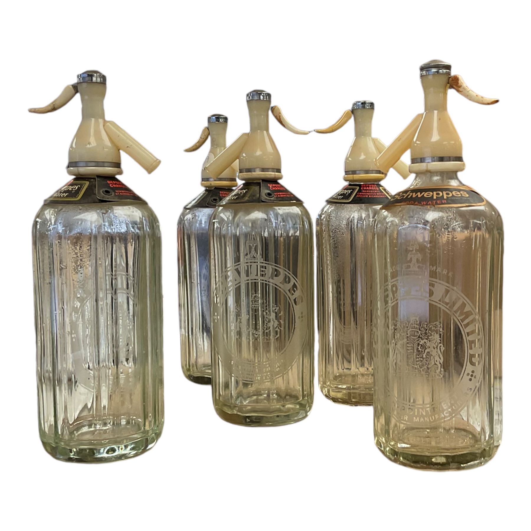 Five Schweppes soda water bottles, together with other vintage glass bottles 