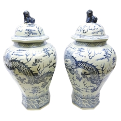 Large pair of Chinese blue & white vases octagonal baluster bodies decorated with four clawed Dragon Chasing Pearl, domed covers with Dog of Fo. finials, H58cm (2)  