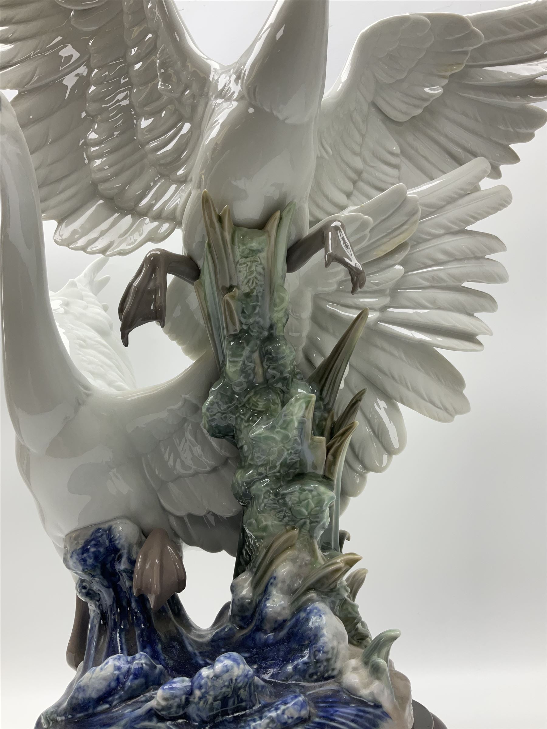 Large Lladro figure group, Swans Take Flight, modelled as two swans upon raised on circular wooden plinth, sculpted by Salvador Debon, H68cm