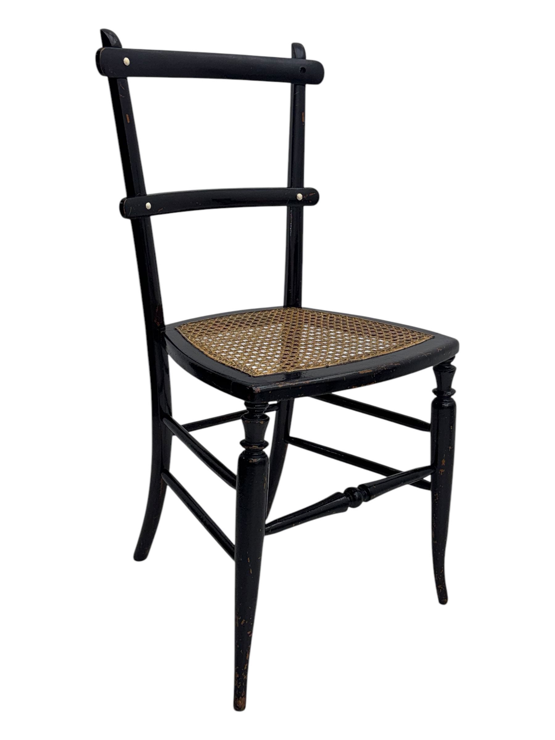 Late 19th century black-painted cane seat chair; early 20th century radial spindle-back chair with green upholstery; early 20th century mahogany single-drawer side table; mid-20th century carved wooden stool with harp motif; early 20th century hexagonal bamboo stand; two oval mirrors (7)