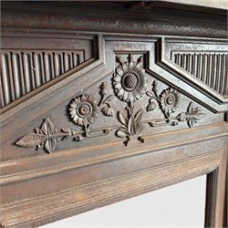 Late Victorian cast ion bedroom fireplace, decorated with floral poppy motifs and flluting