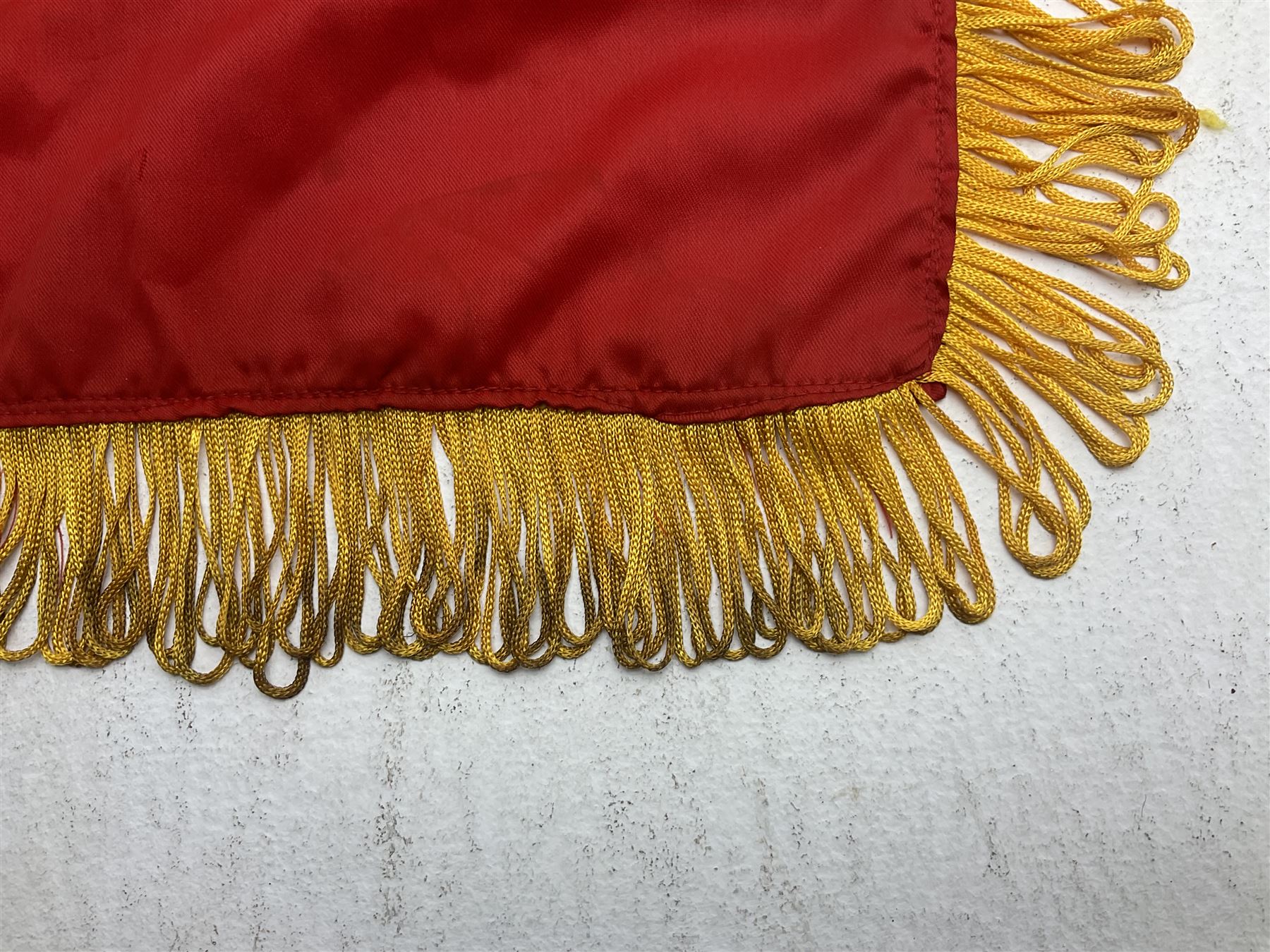 1960s North Vietnam banner embroidered in yellow thread on a red ground, roughly translates as 'Peoples Army of Viet Nam. Warriors of Viet Nam Determined To Keep The Country 1964' around a central military crest with the motto 'Warriors Keep The Country'; tassels to three sides 70 x 100cm