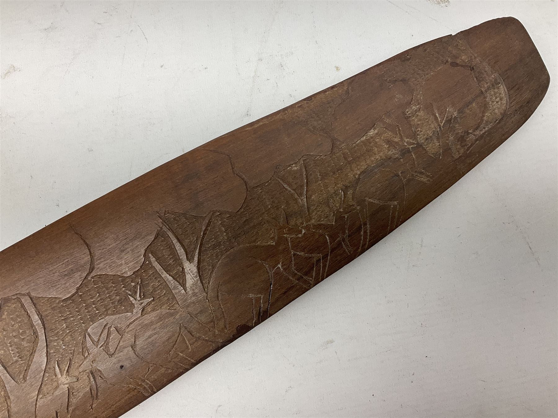 Australian Aboriginal shield, carved with Kangaroo and Emu, 74.5cm; Spear painted with aquatic creatures 78cm, and Spear thrower 81cm (3)