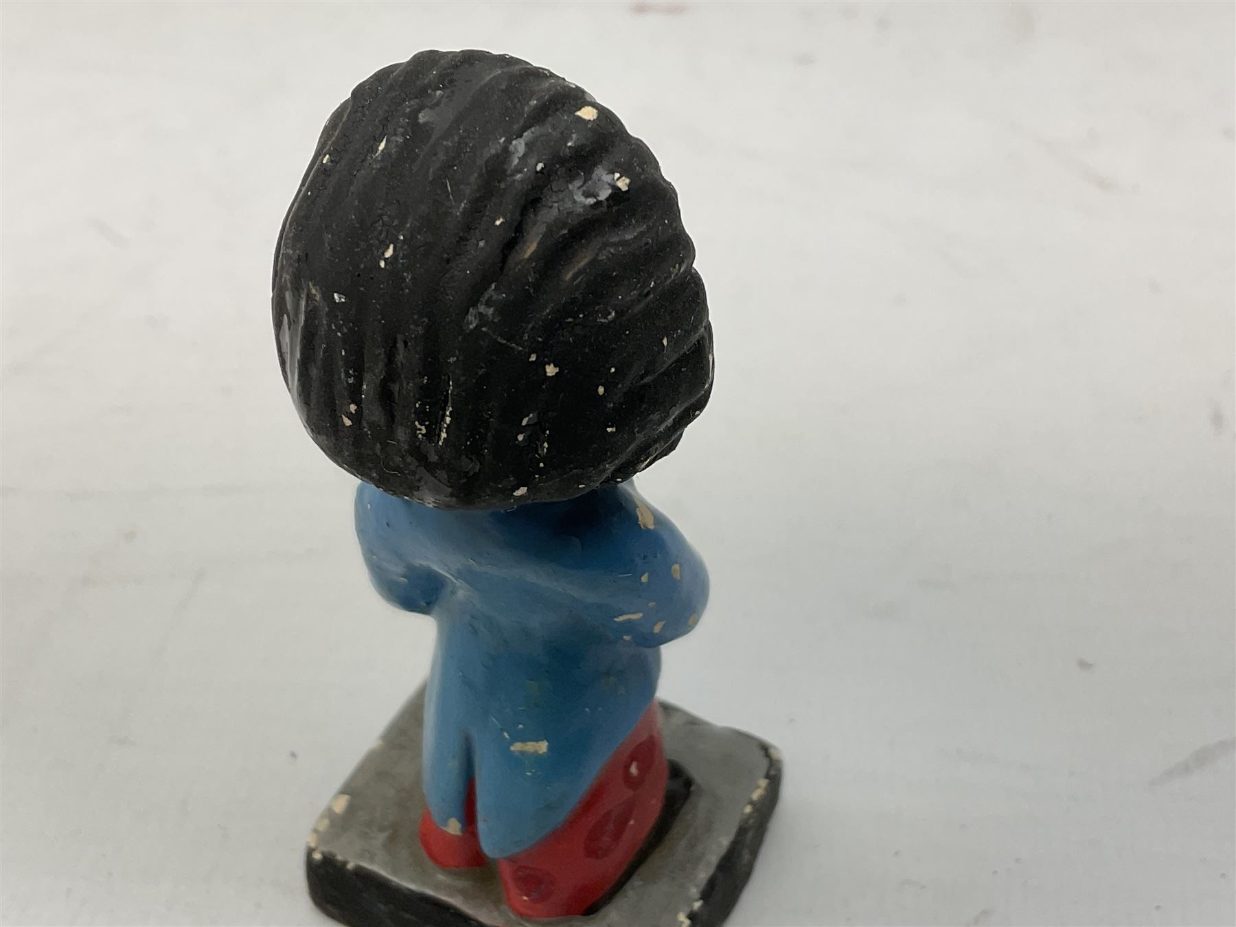 Robinson Jam plaster Golly band, including drummer and singer, H7.5cm

Originally handmade by mothers in Africa for their children from old fabric and cloth, the golly doll was adopted as the mascot and trademark for the Robertson's confectionery brand around 1910 after the company's founder John Robertson visited the US and noticed children playing with them. Robertson's Gollies have been collected by people across the UK and around the world for generations but garnered a contentious image in the 1980s because of links to racism. The trademark was removed from Robertson's branding in 2001.