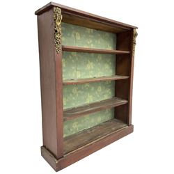 Early 20th century mahogany open bookcase, fitted with three shelves on plinth base, decorated with foliate patterned gilt metal mounts