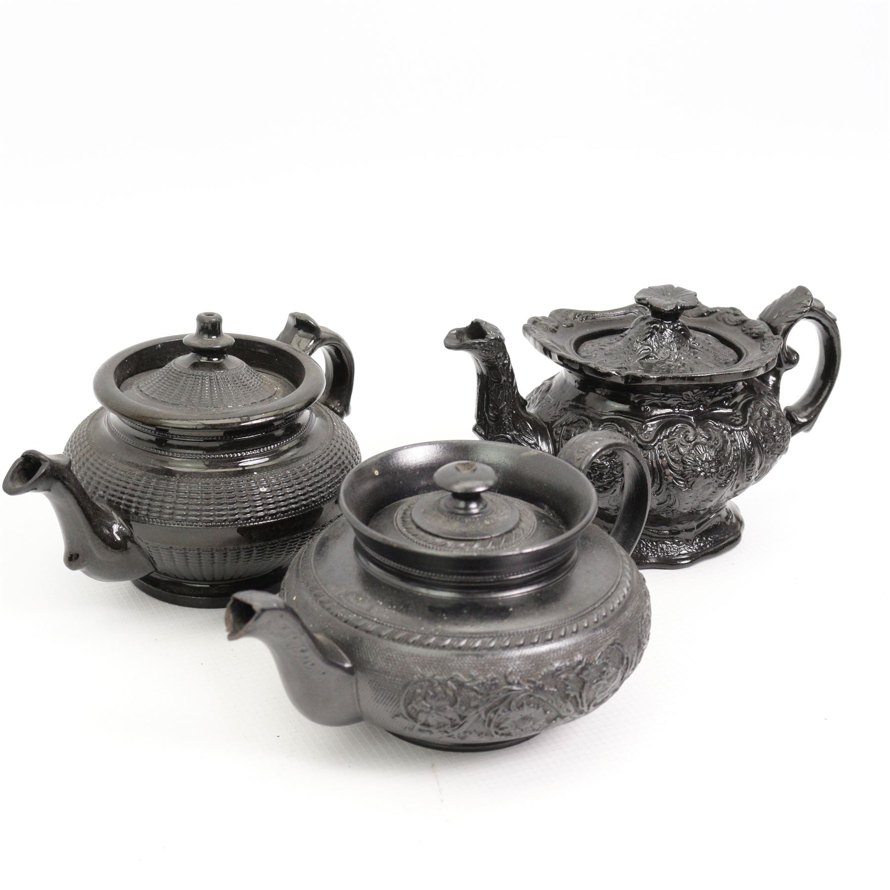 Early 19th century and later black basalt tea wares, mostly with relief or engine-turned bodies, including a Cyples bachelors teapot, other teapots, jugs etc in one box