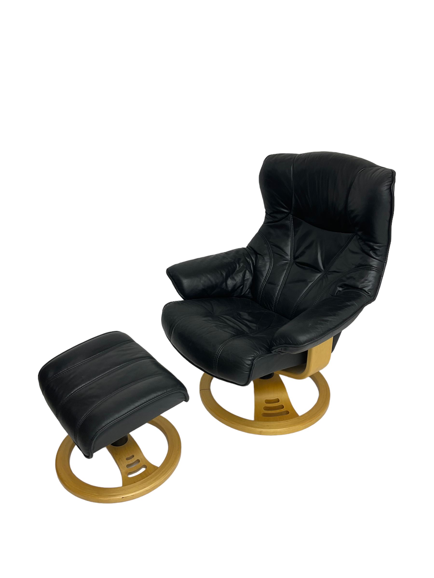 Anderssons of Sweden - mid-20th century design swivel armchair, upholstered black leather, raised on beech U-frame supports with circular base, together with matching footstool 