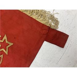 1970s Soviet banner printed in gold on a red ground, roughly translates as 'Transferable Banner - To the winner in the Socialist Competition' and 'Work Study Live by Communism' verso; wreath of wheat ears to either side; tassels on three sides 110 x 155cm