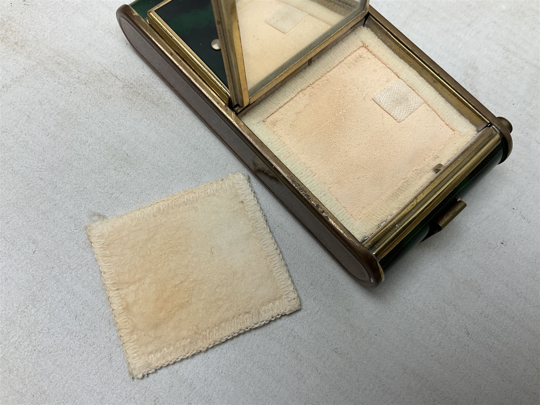 Art Deco camera shaped lady's musical compact and cigarette case, probably German, with green marble effect panels and gilt highlights, with large hinged opening to reveal engine turned brass interior with cigarette or lipstick holders, and the other side with musical mechanism and flip action powder compartment with mirror, L10cm