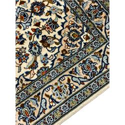 Persian ivory ground runner, the field decorated with six shaped medallions within a field of trailing branches and stylised floral motifs, the guarded border with further floral motifs
