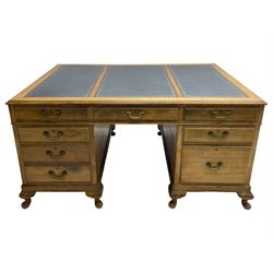 Early 20th century mahogany twin pedestal desk, the moulded rectangular top with three sectional leather insets with gilt decoration, fitted with eight drawers, on cabriole feet