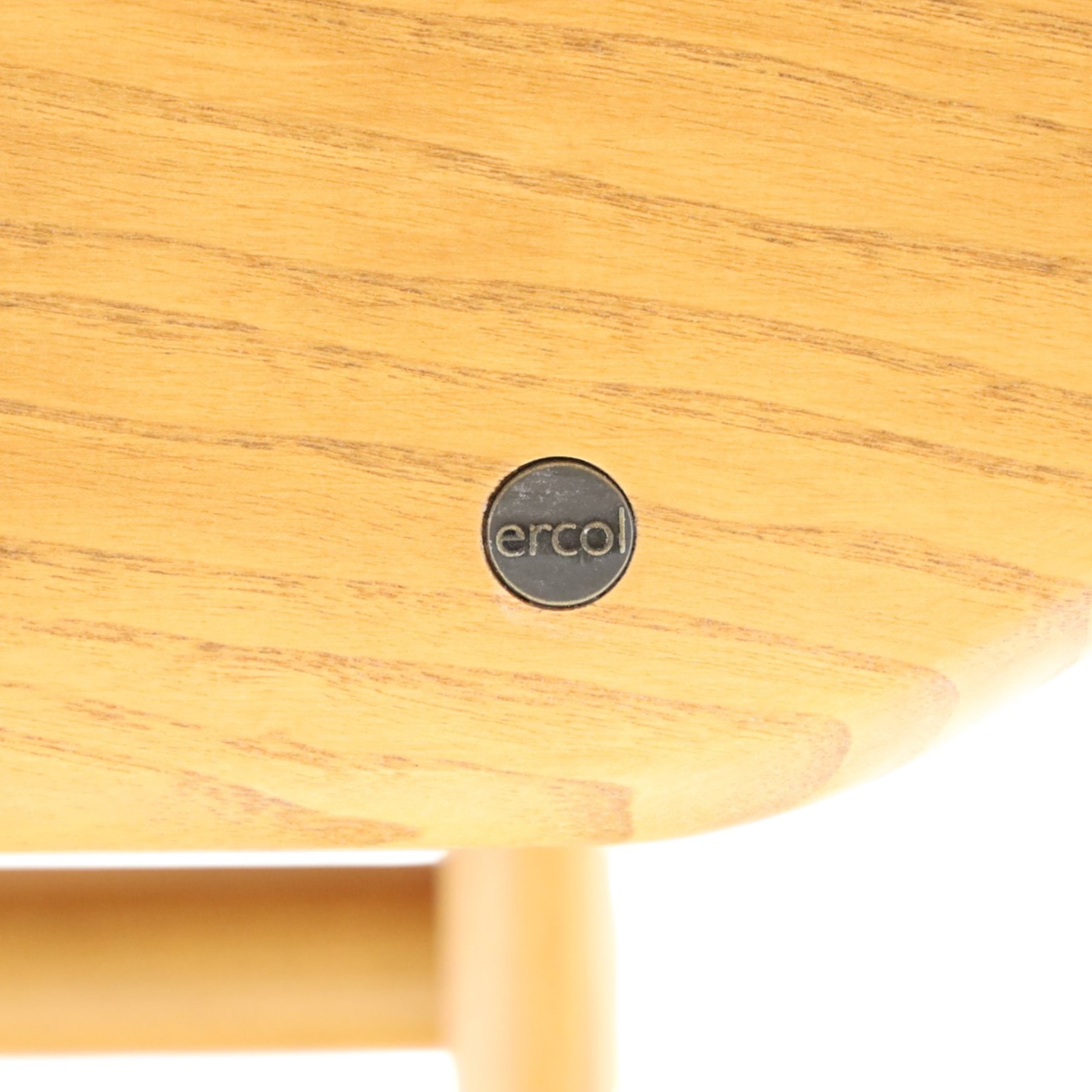 Ercol - 'Windsor' ash medium extending dining table, with stowed fold over leaf extending to 200cm, shaped supports with roundel aperture, united by a stretcher