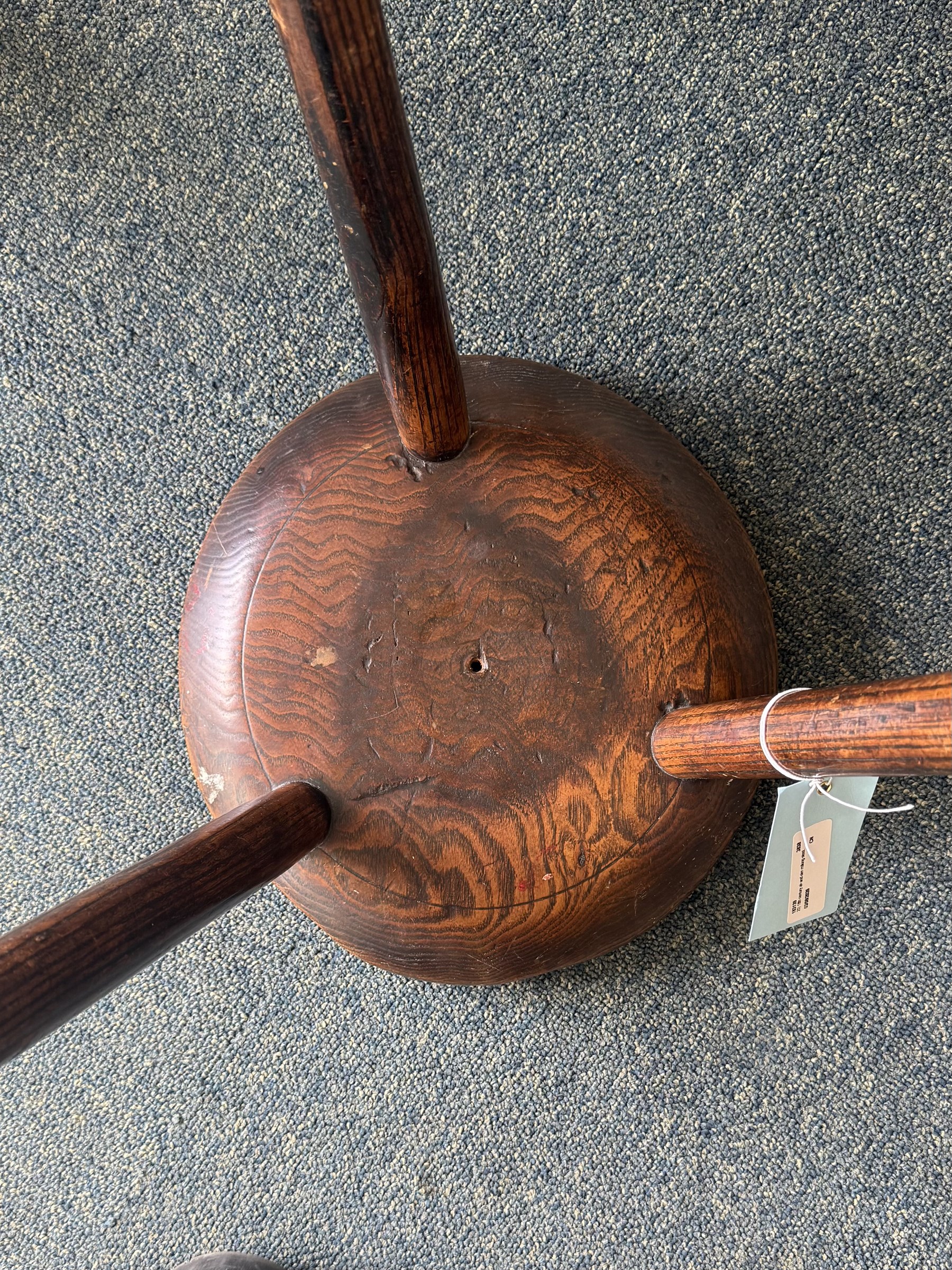 18th century ash and elm milking stool, circular figured top raised on cylindrical supports