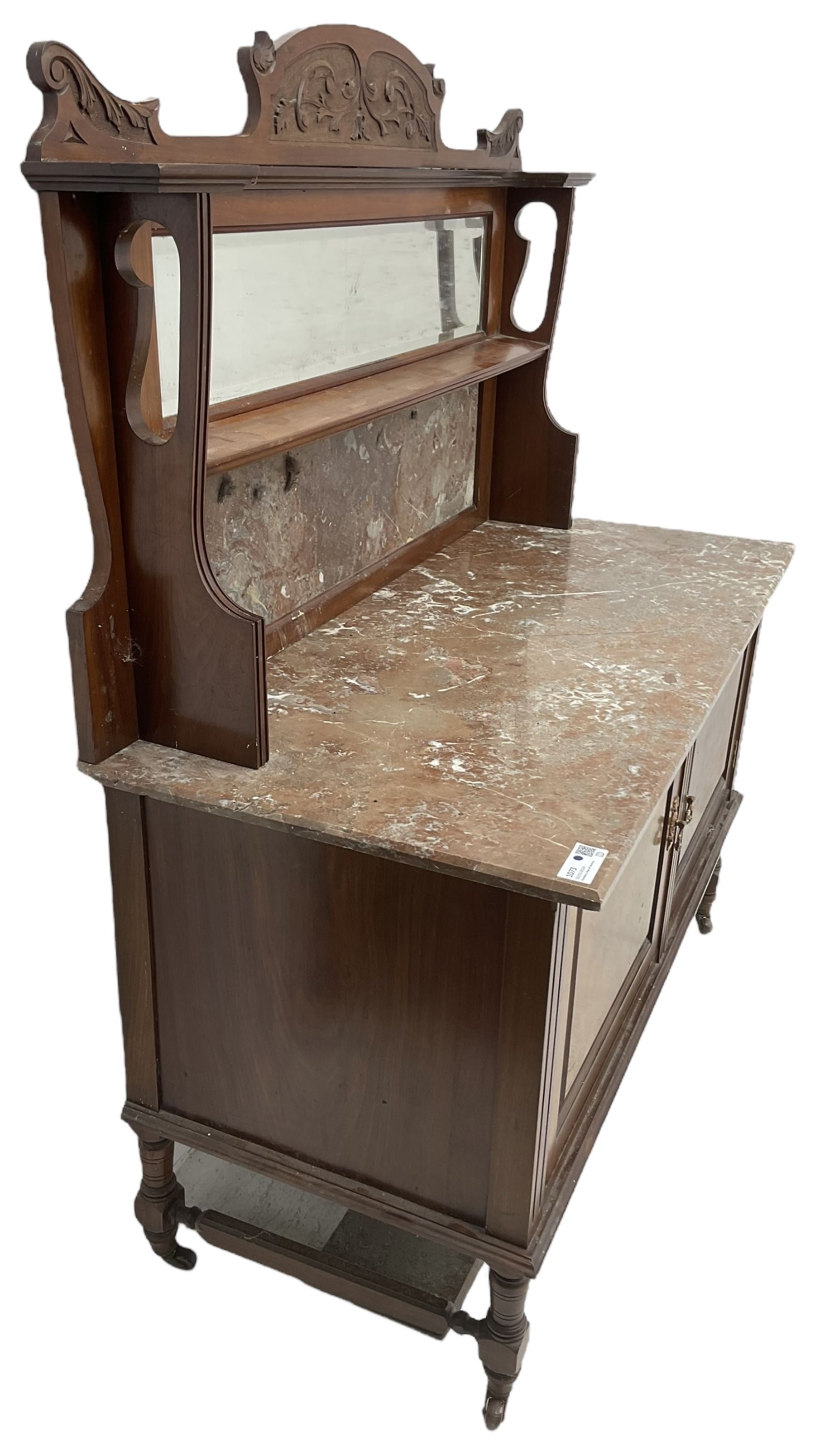 Late Victorian walnut washstand, raised back with carved pediment over bevelled mirror and marble panels, rectangular marble top, fitted with two figured panel doors, on turned supports