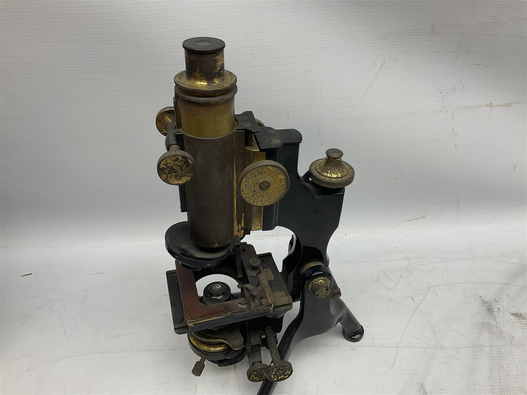 19th century brass and black japanned monocular microscope by W. Watson & Sons Ltd. 313 High Holborn, London serial no.24788 with rack and pinion focussing on tripod base H31cm; in fitted mahogany case retailed by A.H. Baird Scientific Instrument Makers Edinburgh; quantity of additional lenses and accessories; together with another similar uncased monocular microscope by W. Watson serial no.58379 (2)