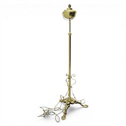 20th century brass standard lamp, urn form reservoir top with hinged cover, on a slender column with knopped detail, the stem fitted with scrolling supports, raised on a triform base with shaped cabriole supports terminating in pad feet